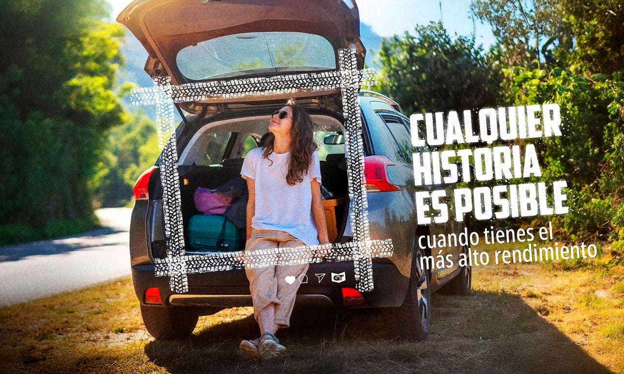 Una mujer sentada en el maletero de un coche en una carretera rodeada de árboles, con maletas alrededor. El entorno es tranquilo y hay un filtro con marcas de neumáticos. El texto dice: "Cualquier historia es posible cuando tienes el más alto rendimiento." La imagen sugiere que los viajes son impulsados por el rendimiento de los neumáticos General Tire.